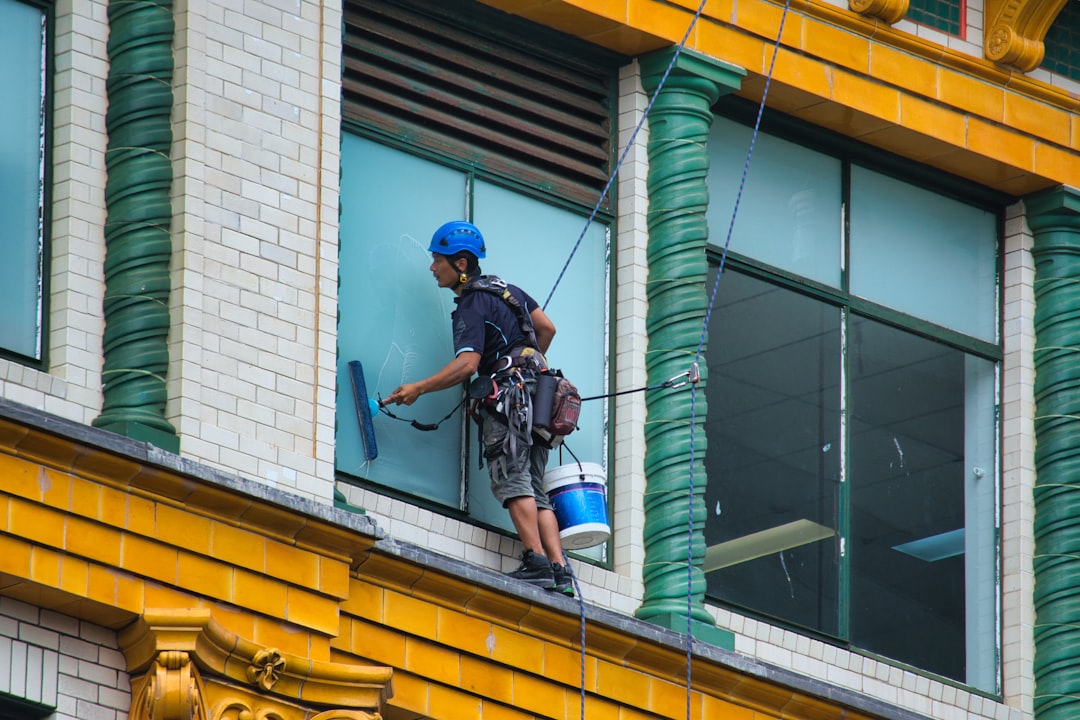 our-story A window cleaner cleaning the windows of a building.
